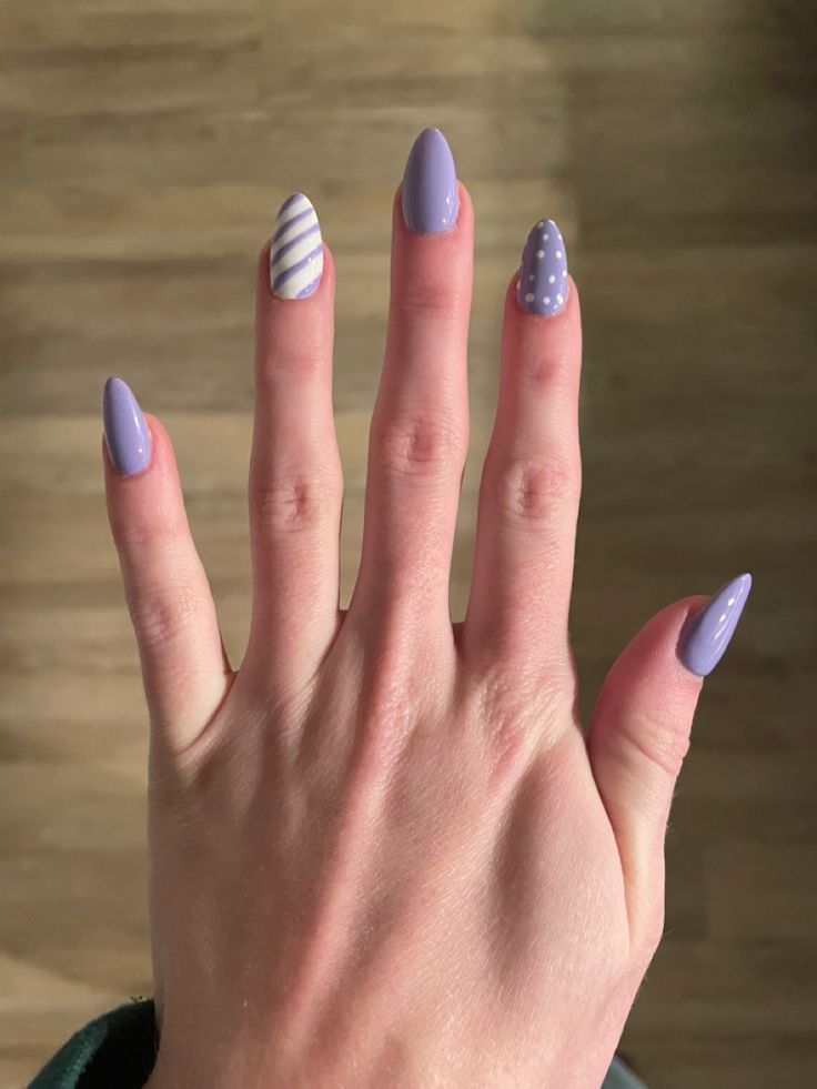 Purple striped and polka dotted nails
