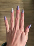 Purple striped and polka dotted nails