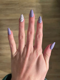 Purple striped and polka dotted nails